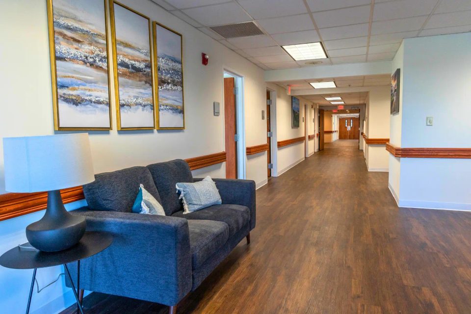Arista Recovery Ohio: Residential wing hallway and comfortable lounge seating at the Hilliard campus
