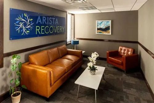 Arista Recovery Overland Park: Reception lobby with Arista Recovery wall sign and orange leather seating in Overland Park