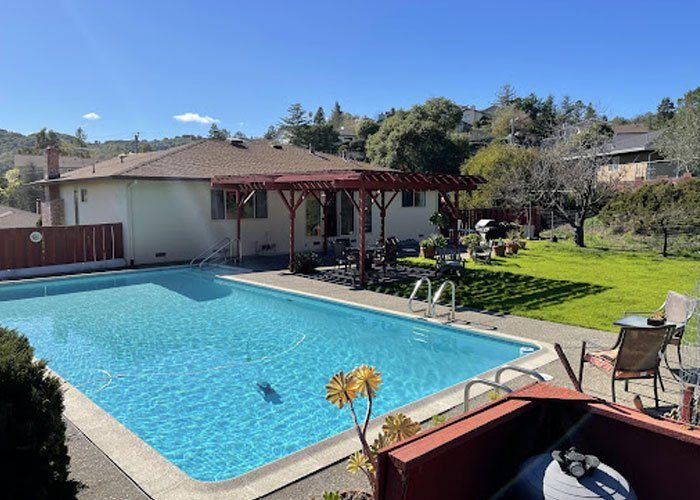 Golden Gate Recovery: Backyard swimming pool and shaded patio at the Marin County supportive housing residence