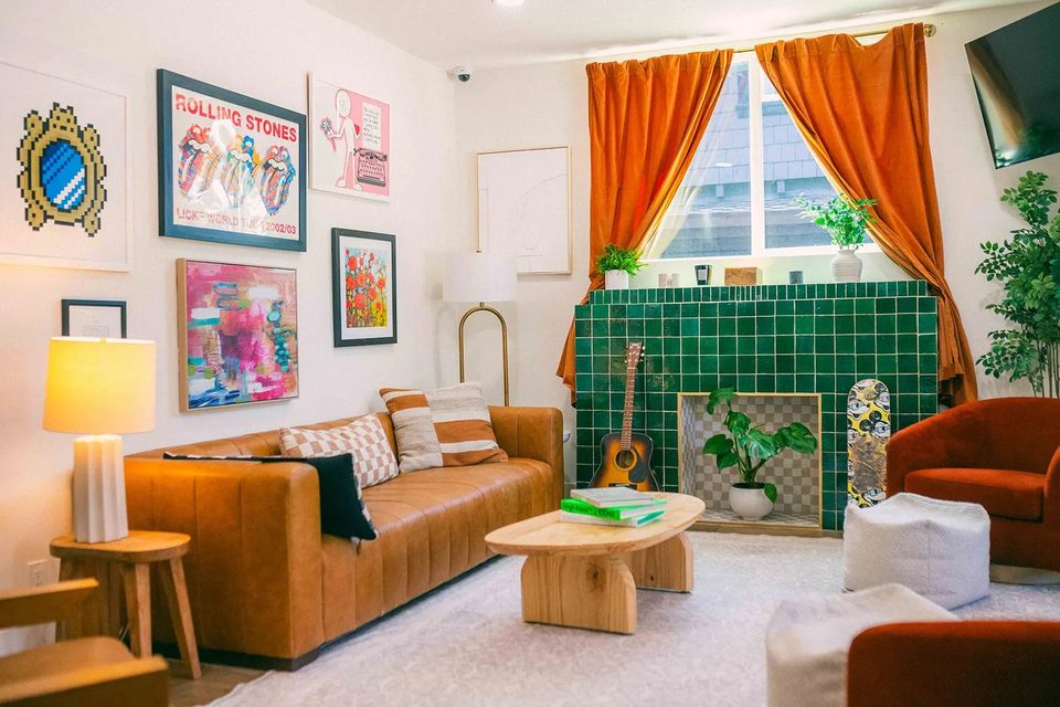 Numa Recovery Centers: Resident community living room with leather sofa and green tile fireplace